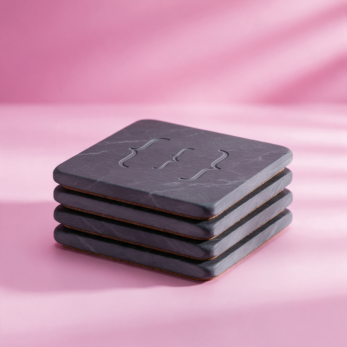 Stack of four engraved slate coasters with cork backing